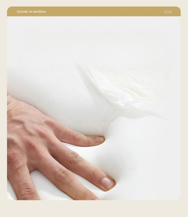 Hand touching a soft, white mattress surface