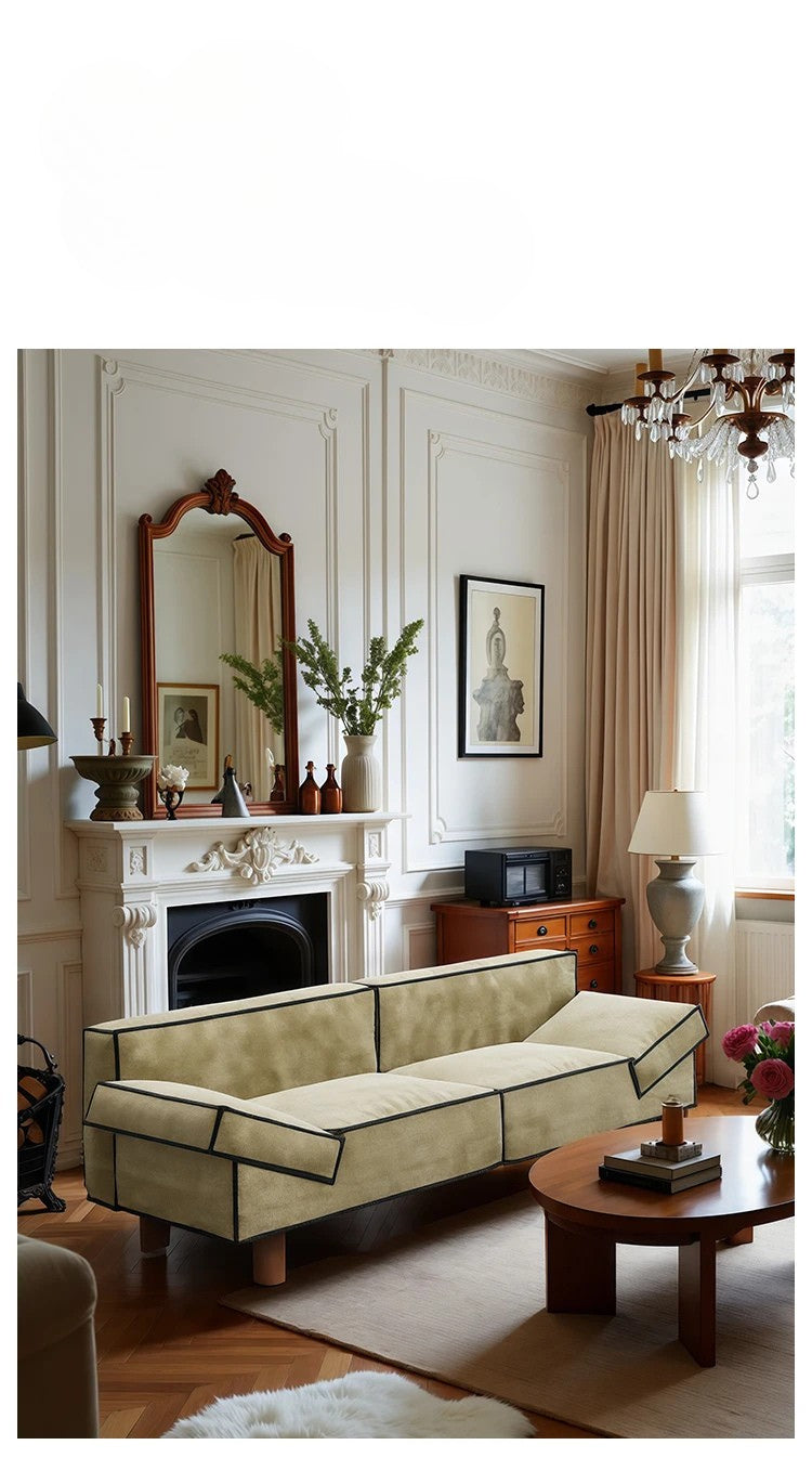 Living room with beige sofa, fireplace, and decorative items.