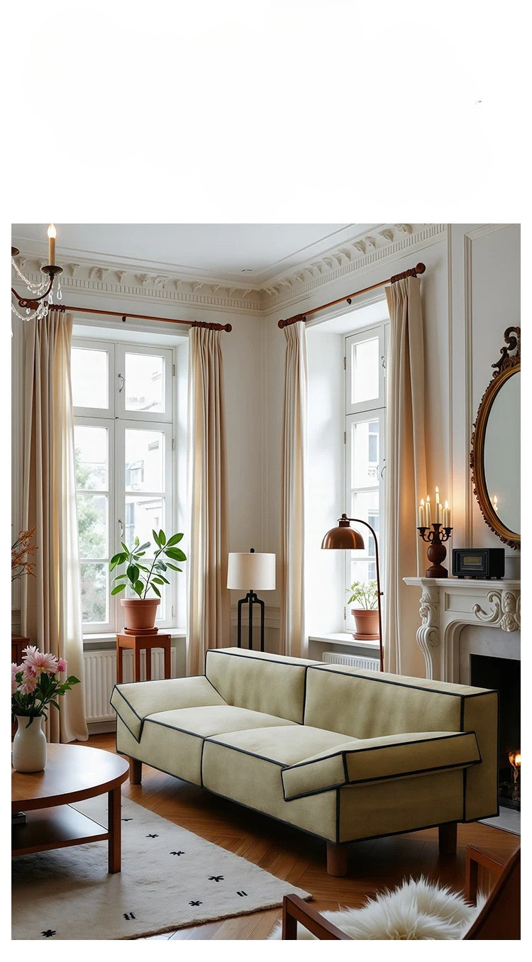 Living room with beige sofa, round table, and decorative elements.