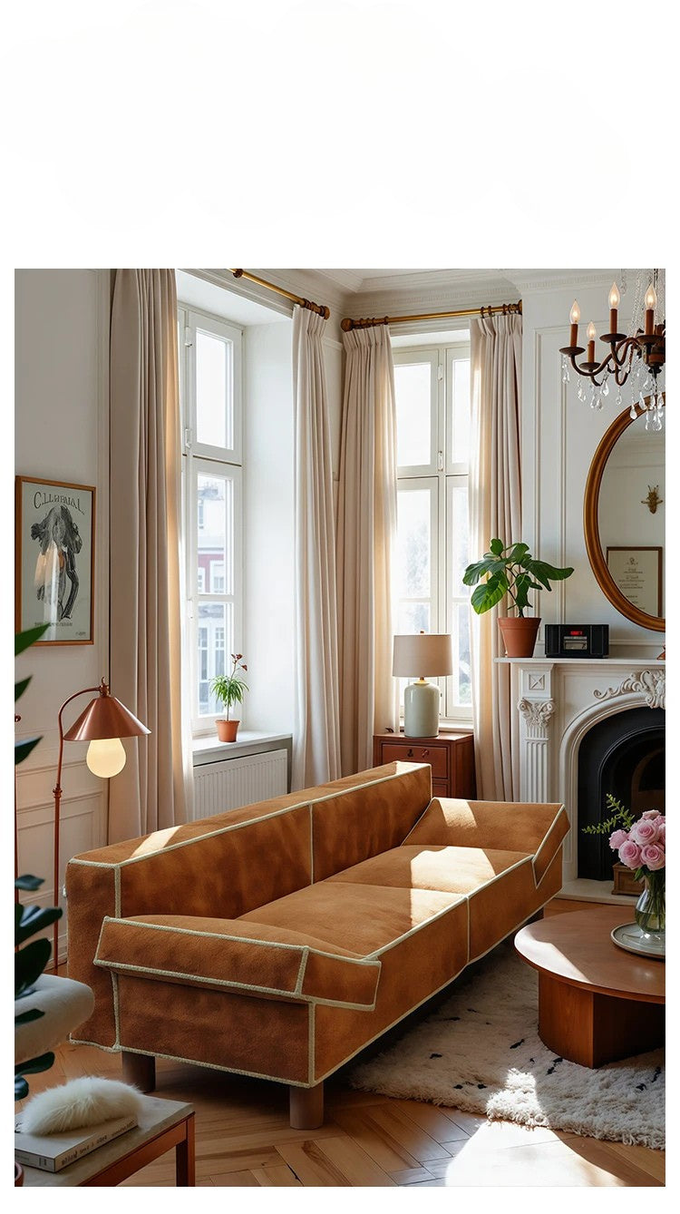 Living room with a brown sofa, fireplace, and decorative items.