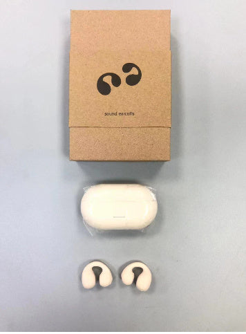 White earbuds with a cardboard box on a gray background