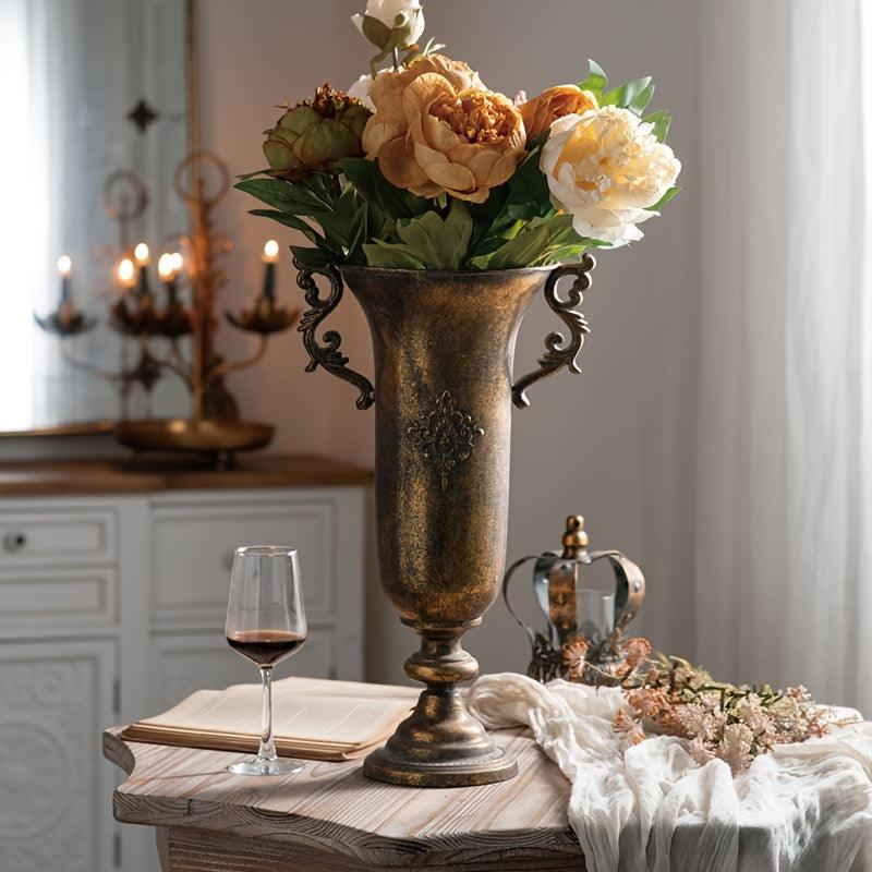 Decorative metal vase with handles for vintage-inspired decor.