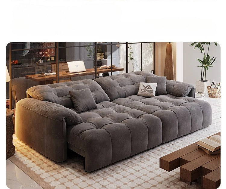 Gray sectional sofa in a living room setting with decor elements.