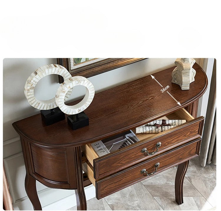 Wooden console table with open drawer, decorative items, and mirror in the background.