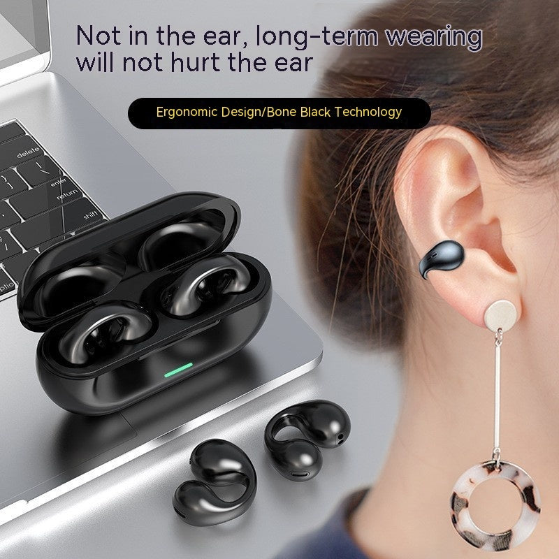Black wireless earbuds with charging case on a laptop, showing ear usage.