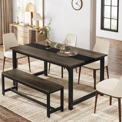 Dining room setup with a dark wooden table, chairs, and bench on a wooden floor.