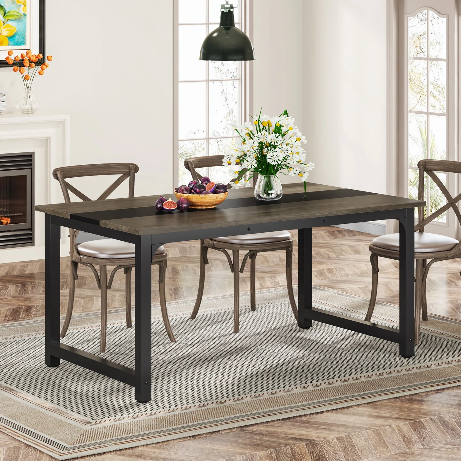 Dining room with a black dining table and chairs, flowers, and fruit on the table.