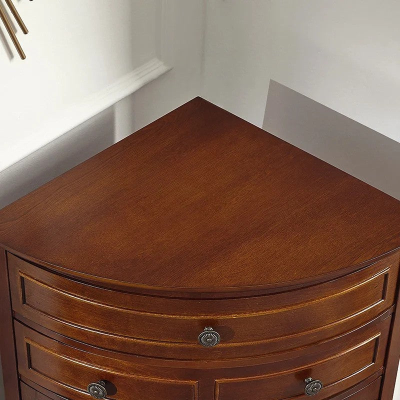 Wooden corner cabinet with curved design and two drawers.