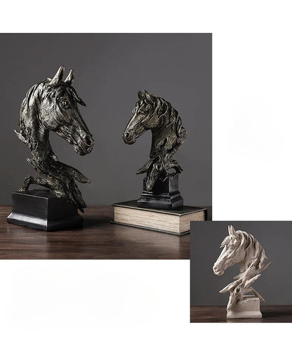 Bronze horse head sculptures on books with a dark background