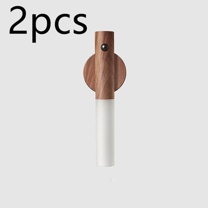 Wooden and white wall hook on a light gray background with &