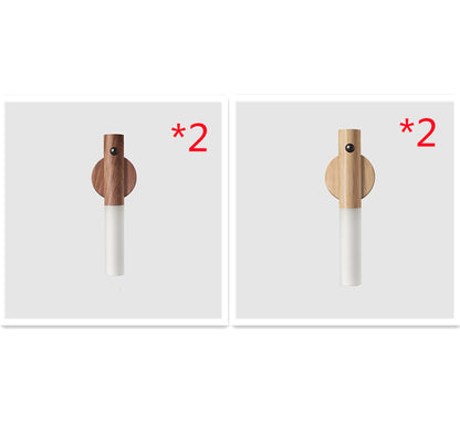 Two wooden and white cylindrical objects with a &