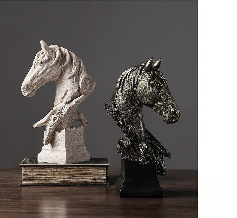 Two horse head sculptures on wooden bases against a dark background