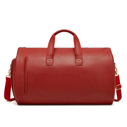 Red leather duffel bag with handles and a shoulder strap on a white background
