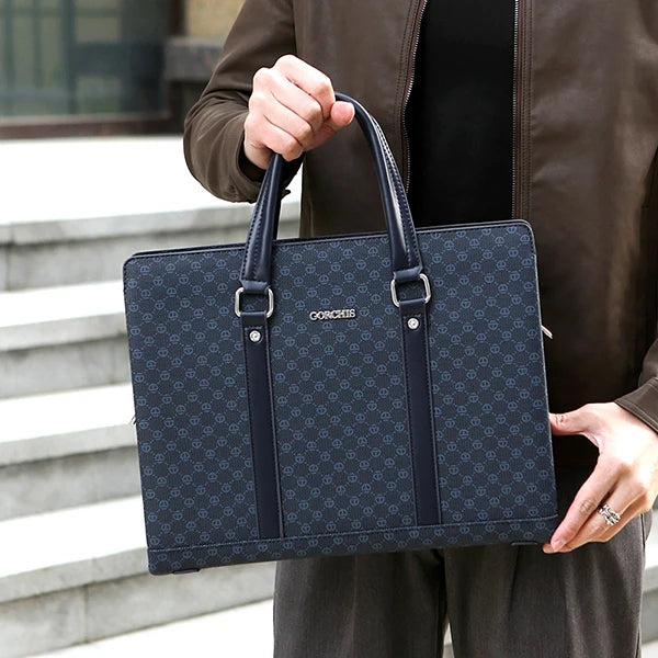 Person holding a blue patterned briefcase with a visible brand logo.