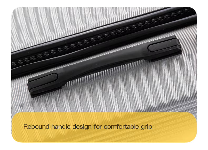 Close-up of a suitcase handle on a textured surface with a yellow label.