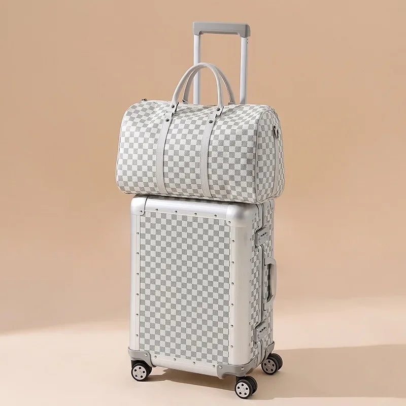 Checkered patterned suitcase and duffel bag on a beige background