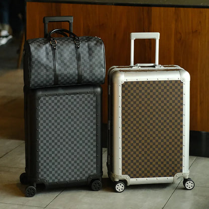 Four suitcases with checkered pattern on a tiled floor.