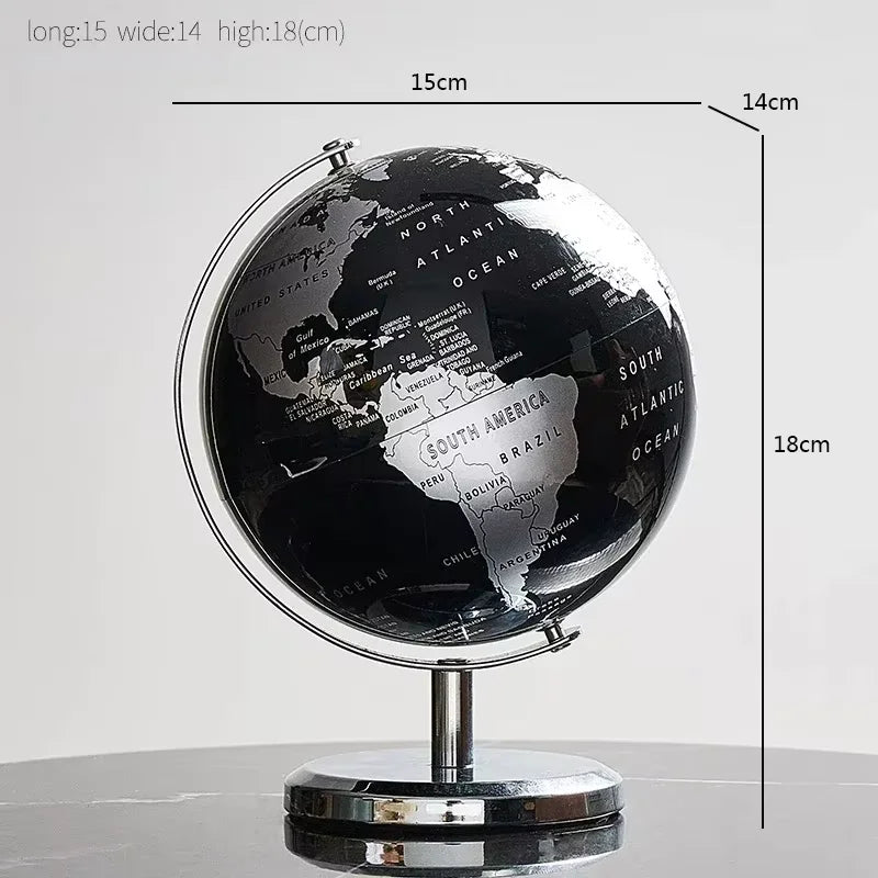 Black and silver world globe with measurements on a light gray background