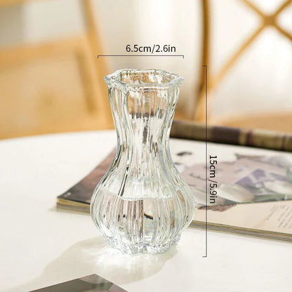 Clear glass vase on a surface with dimensions indicated