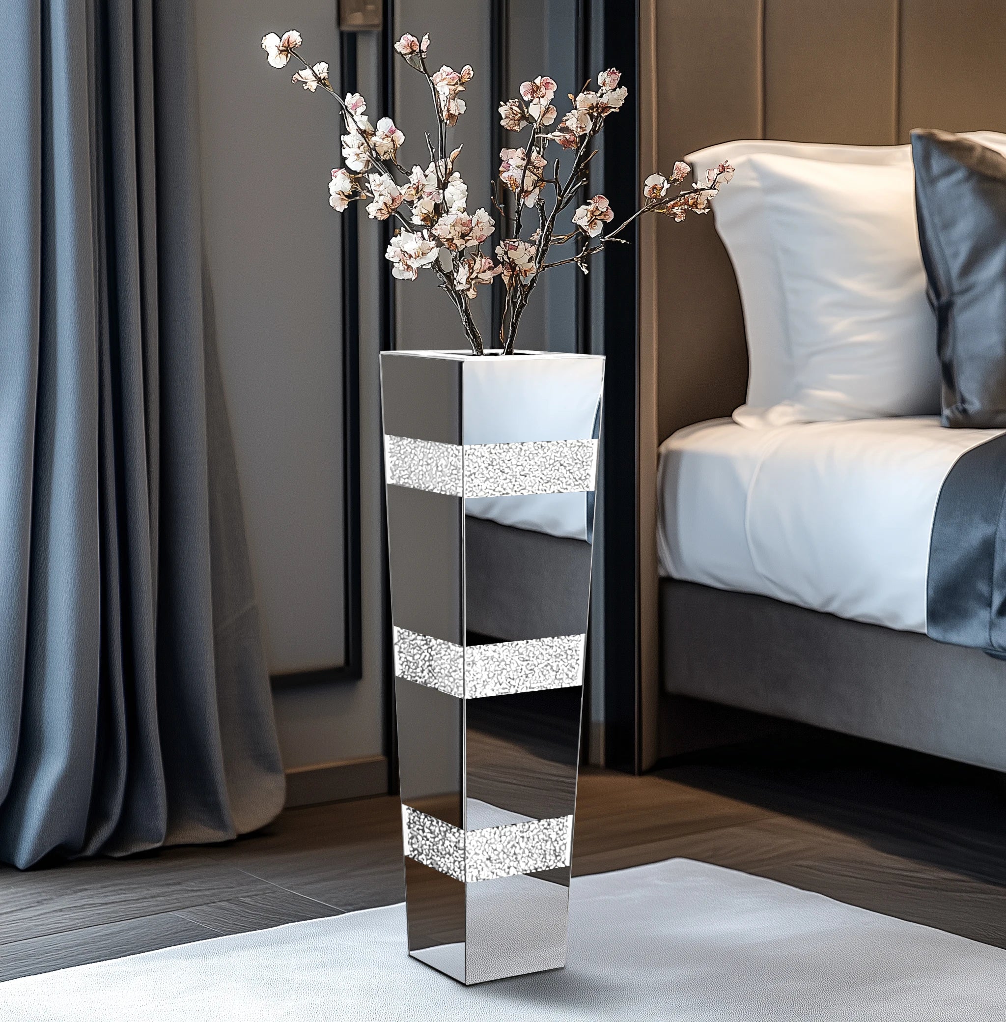Decorative mirrored vase with floral arrangement on a nightstand next to a bed.