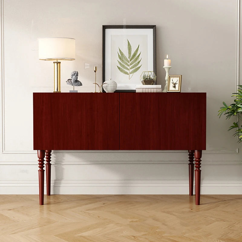 Wooden console table with decorative items against a light wall.