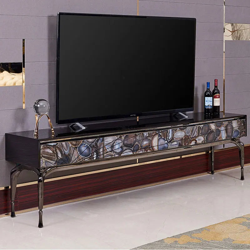 Modern TV stand with decorative stones and a television on a gray wall background