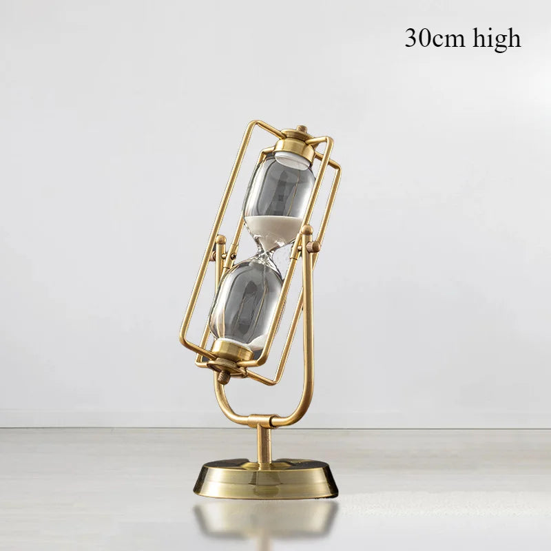 Gold hourglass-shaped lamp on a white background with &