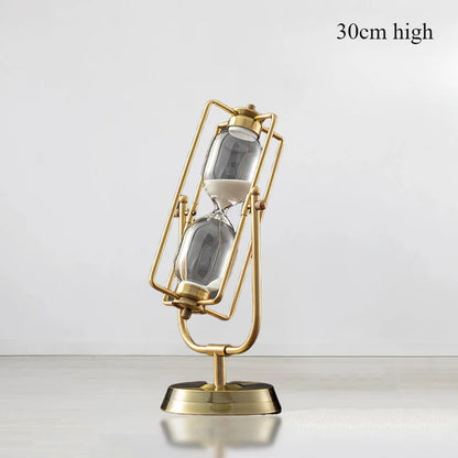 Gold hourglass-shaped lamp on a white background with &