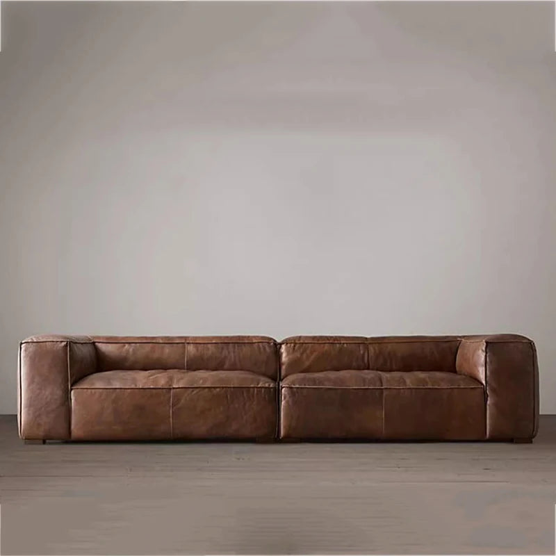 Brown leather sofa against a plain wall