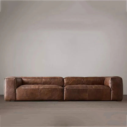 Brown leather sofa against a plain wall