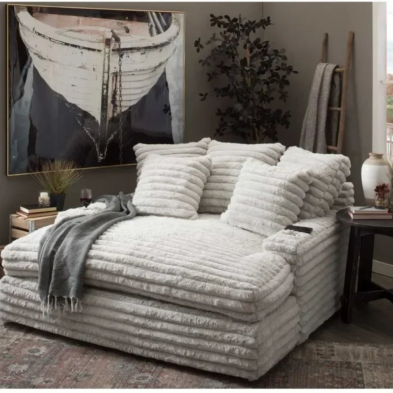 Cozy living room with a textured sofa, decorative pillows, and a large painting of a boat.