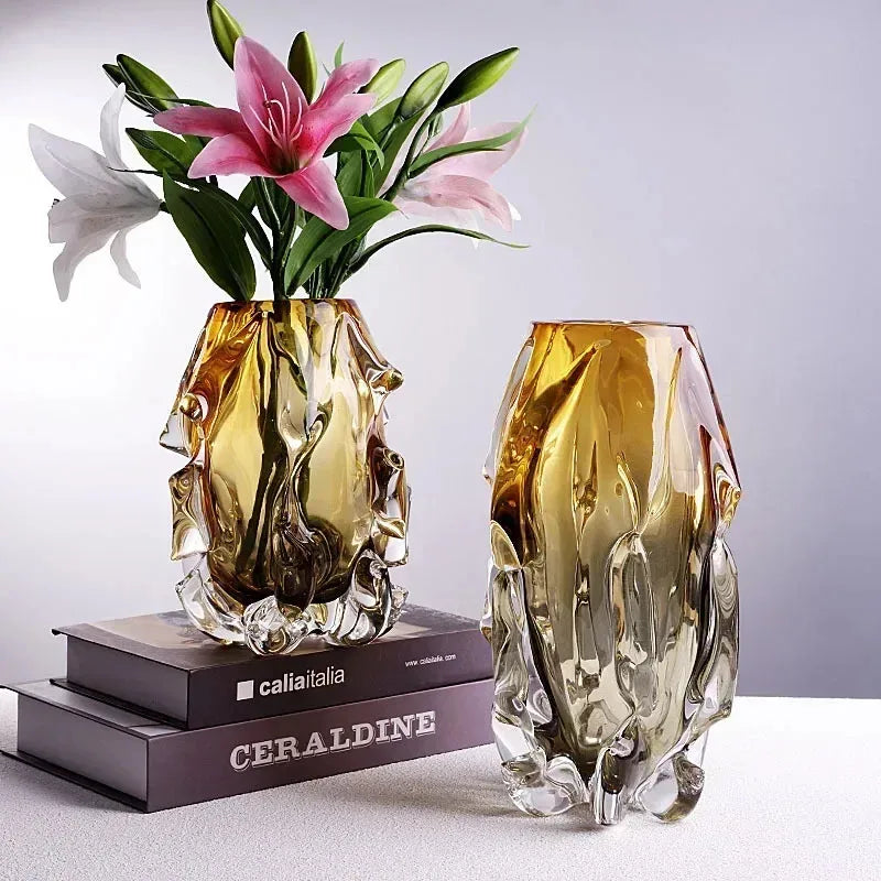 Two decorative glass vases with flowers on a light gray background
