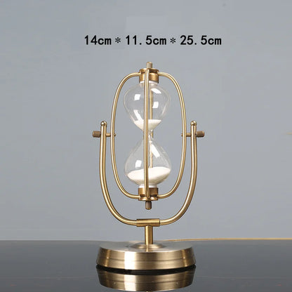 Gold hourglass-shaped table lamp on a gray surface with dimensions displayed.