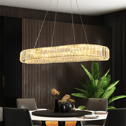 Large rectangular crystal LED chandelier in polished chrome, illuminating a modern dining room with elegance.