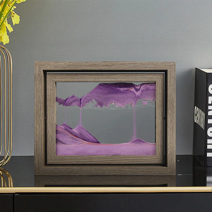 Framed abstract artwork with purple and pink hues on a gray surface.