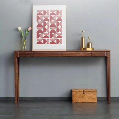 Wooden console table with decorative items against a gray wall