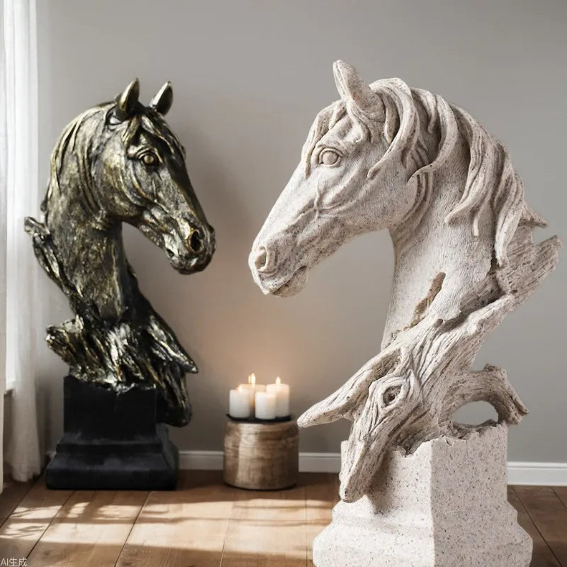 Two horse head sculptures, one bronze and one stone-like, in a room with candles on a small table.