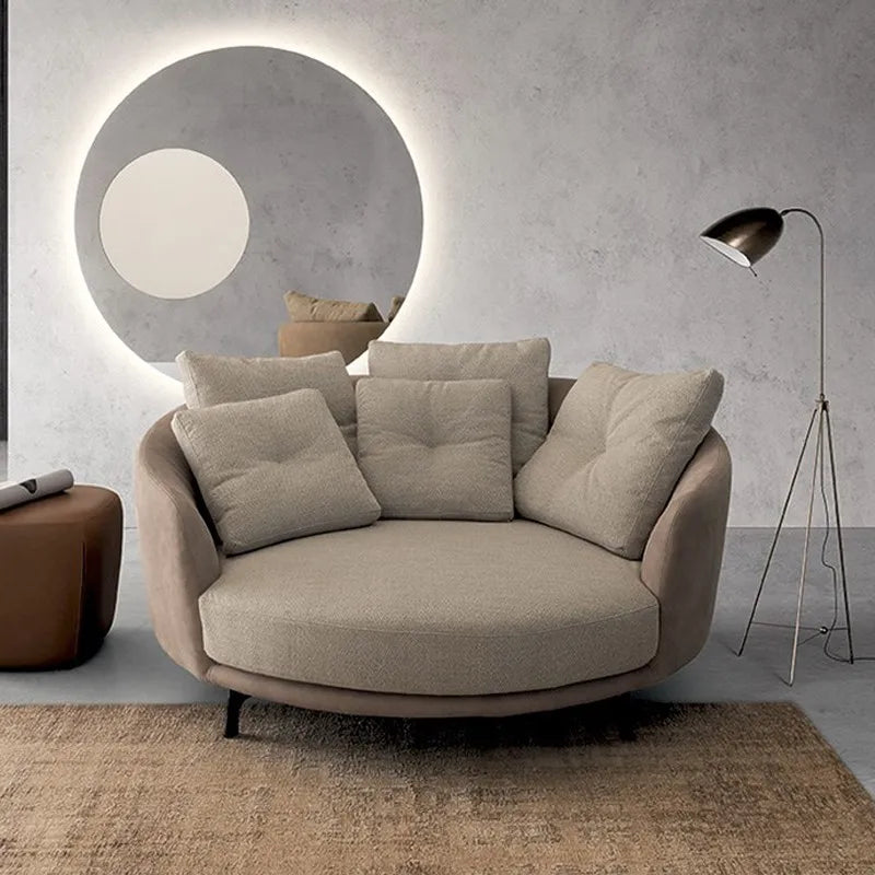 Modern beige sofa in a stylish living room with a round mirror and floor lamp.