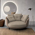 Modern beige sofa in a stylish living room with a round mirror and floor lamp.