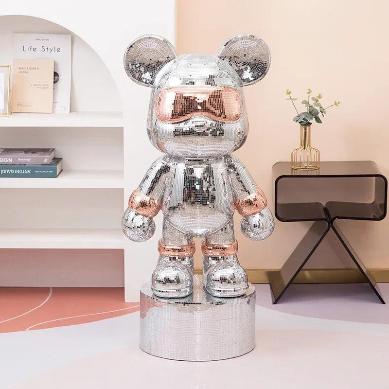 Front view of the reflective Disco Mirror Bear Sculpture on a modern coffee table.