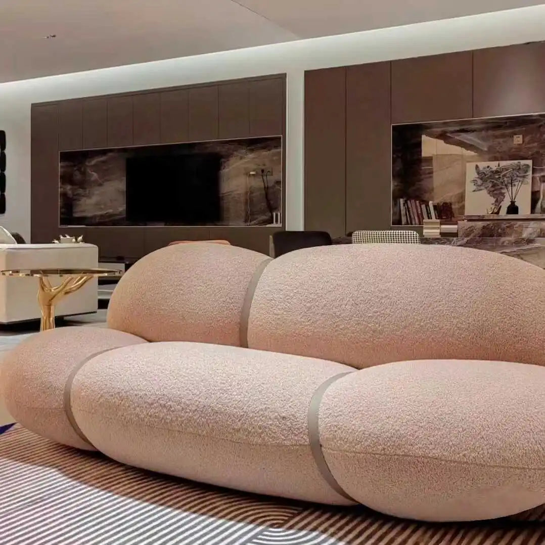 Modern living room with a unique beige sofa in the foreground