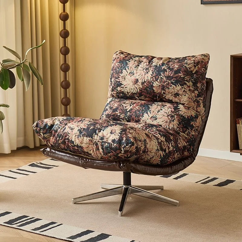 Floral-patterned armchair in a living room setting with a rug and plant.