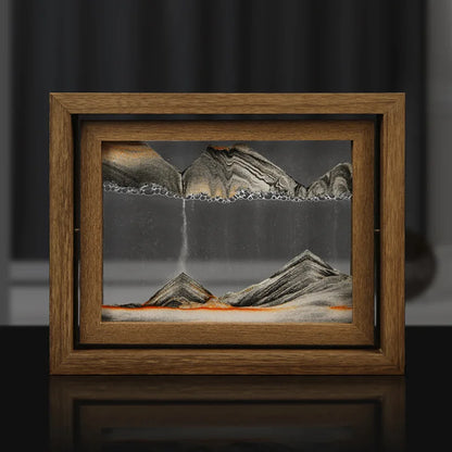 Framed artwork of a mountain landscape with a waterfall on a dark background