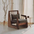Modern armchair with wooden frame and grey cushion in a room with curtains and a small table.