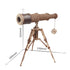Vintage-style telescope on a tripod with measurements indicated