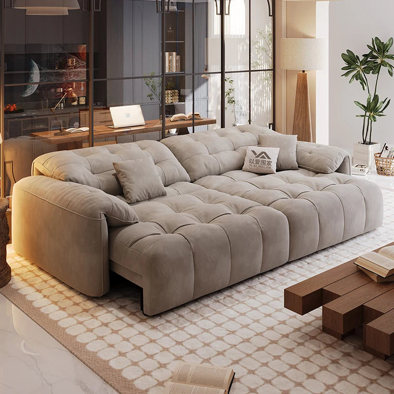 Large beige sectional sofa in a modern living room with a coffee table and decorative items.