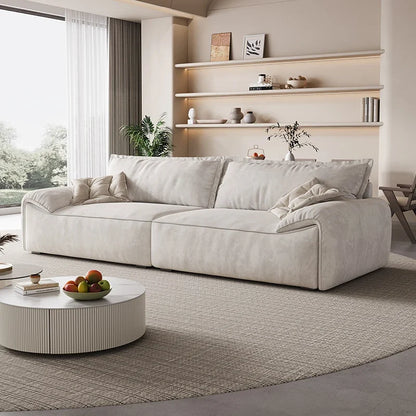 Beige sofa in a modern living room with shelves and a coffee table.