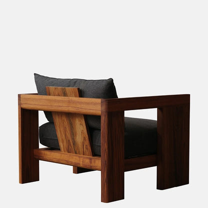 Wooden armchair with dark cushions on a white background