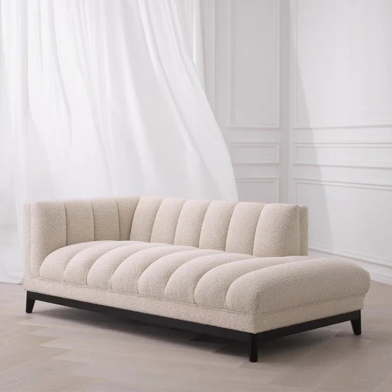 Beige sofa in a room with white curtains and walls