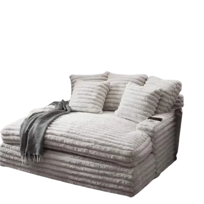 Gray plush sofa with cushions and a blanket on a white background